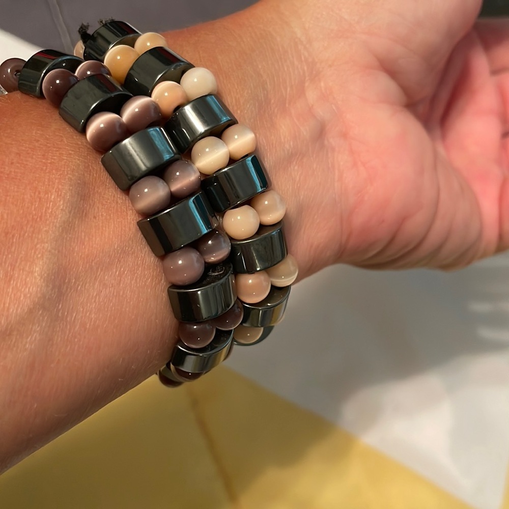Pair of hematite bracelets. Purple and pink accent beads